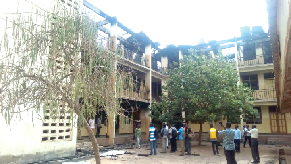 The two-storey domitory gutted by fire. (INSET) The belongings of the students that were salvaged from the inferno The two-storey domitory gutted by fire. (INSET) The belongings of the students that were salvaged from the inferno