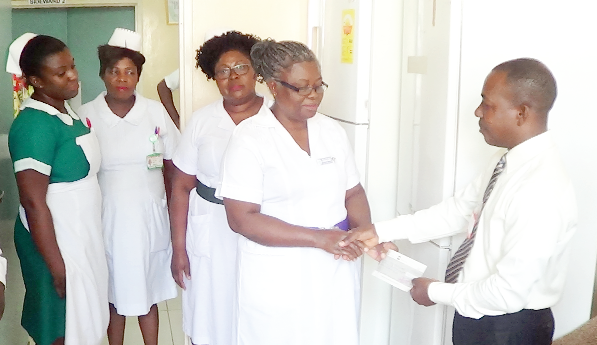 Mr Emmanuel Agyei Arthur (right), presenting the cheque to Mrs Juliana Johnson-Gawu. Picture: INNOCENT K. OWUSU Mr Emmanuel Agyei Arthur (right), presenting the cheque to Mrs Juliana Johnson-Gawu. Picture: INNOCENT K. OWUSU
