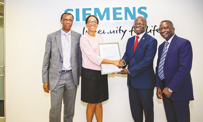  Janina Kugel (Second left) presenting a proof of the donation to Professor Mark Adom-Asamoah, Provost of the College of Engineering at Kwame Nkrumah University of Science and Technology.