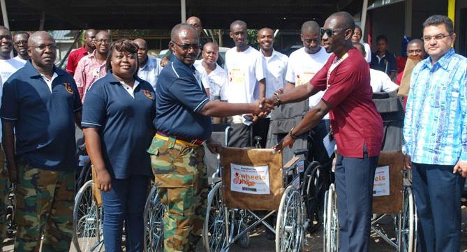 Rotarian Lamtiig Apanga (2nd right) presenting the wheelchairs to Brig. Gen. E. C. Saka Jnr Rotarian Lamtiig Apanga (2nd right) presenting the wheelchairs to Brig. Gen. E. C. Saka Jnr