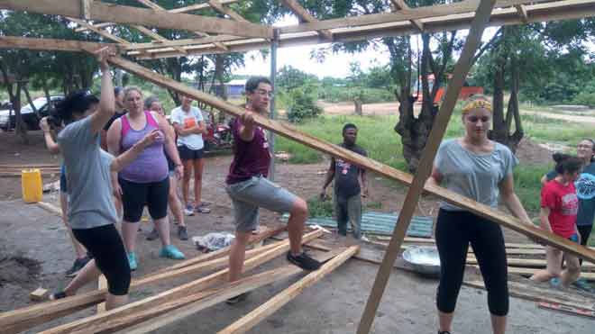 The students busily constructing child welfare clinic shade at Fiankonya in the Shai Osudoku District