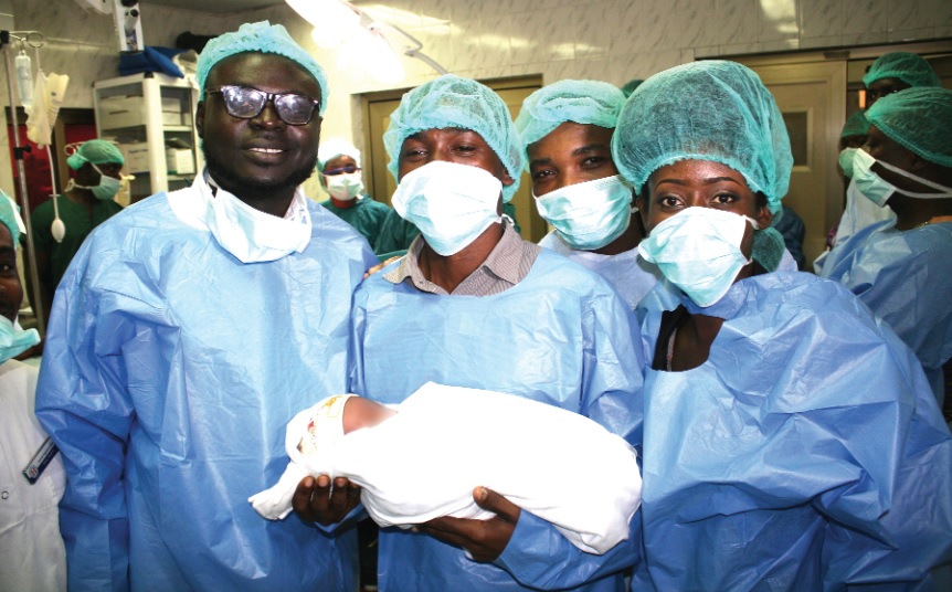 Some journalist with the baby after the operation Some journalist with the baby after the operation