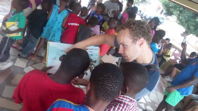 The students in a reading and interaction session with children of Kumasi Children's Home