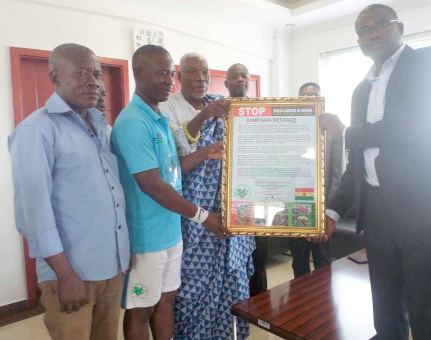 Torgbui Gobah Tengey Seddoh (in cloth) and Mr Harry Ahorlu presenting the campaign message to Dr Clifford A. Barimah
