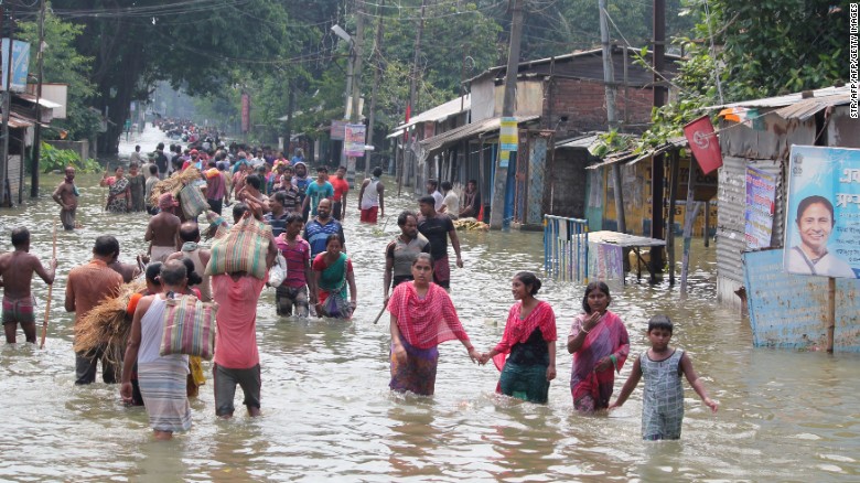 Residents wade through flood waters in the Indian state of West Bengal on August 17. Residents wade through flood waters in the Indian state of West Bengal on August 17.