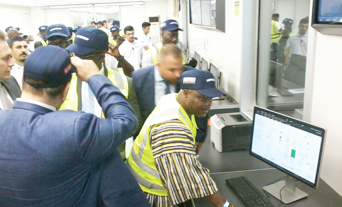 Mr Joseph Cudjoe, (in smock), the Deputy Minister of Energy, pressing a comtrol button to mark the start of operation of the second power barge, Osman Khan. With him is Orhan Remzi Karadeniz the CEO, Karpowership (left) and other guests