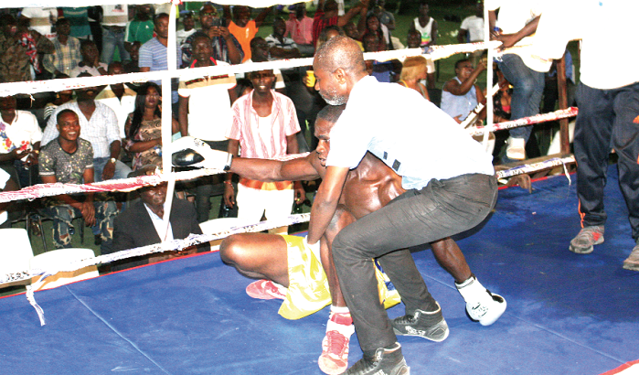 Referee Roger Barnor struggles to raise a dazed Kwadey from the floor after his knock down. Referee Roger Barnor struggles to raise a dazed Kwadey from the floor after his knock down.