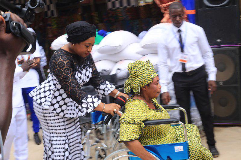Foreign Minister assisting a physically challenge who was presented with a brand new wheel chair by the church