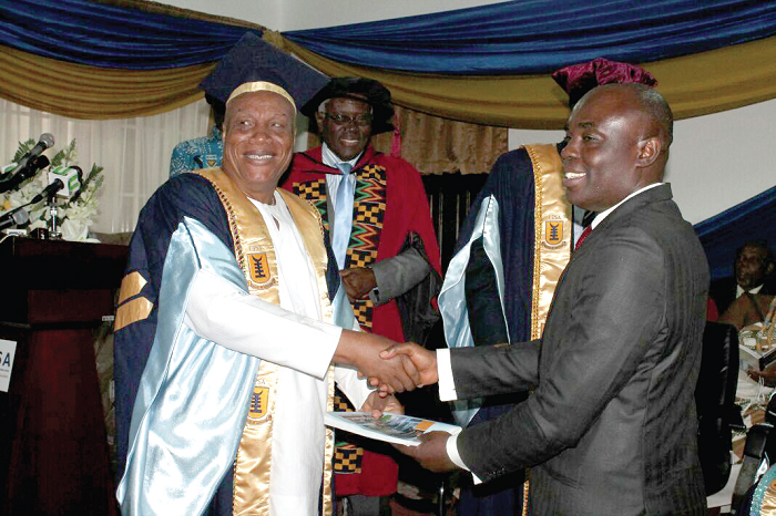  Prof. Joshua Alabi (left), handing over notes to Prof Abednego Feehi Okoe Amartey, Incoming Vice-Chancellor of UPSA