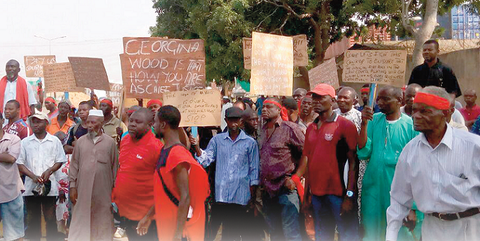  The aggrieved ex-port workers holding placards to send home their demands
