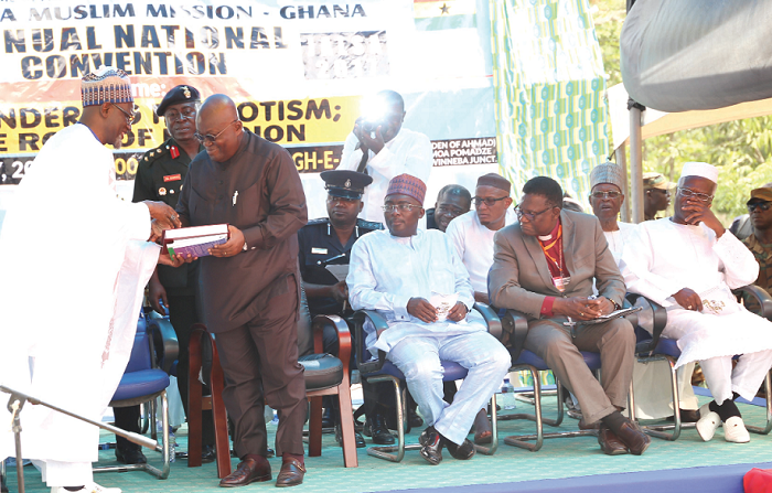   Alhaji Maulvi Mohammed Bin Salih (left), Ameer and Missionary In -charge, Ahmadiyya Muslim Mission Ghana, presenting a Quran to President Akufo-Addo. 