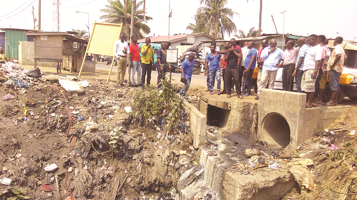 Mr Eben Nartey (2nd right) showing a drain to engineers from the Department of Urban Roads PICTURE BY EMMANUEL QUAYE Mr Eben Nartey (2nd right) showing a drain to engineers from the Department of Urban Roads PICTURE BY EMMANUEL QUAYE