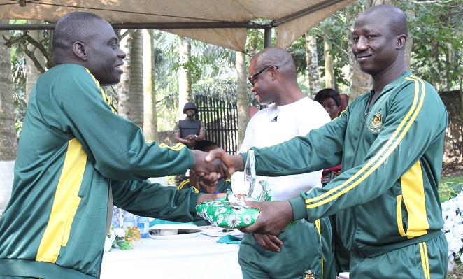 Mr Yaw Sarpong (left) presenting an award to Mr David Atinka Abakisi (right) who won the most disciplined senior officer for the year 2016