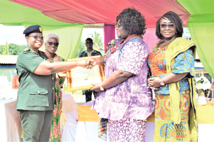 • Prof. Henrietta Mensah-Bonsu (2nd right), Snr lecturer, University of Ghana law faculty, being assisted by Ms Gomashie to present the citation to Brigadier-General Edjeani-Afenu at the event, while Madam Baku (grey haired) looks on. Picture: DELLA RUSSEL OCLOO • Prof. Henrietta Mensah-Bonsu (2nd right), Snr lecturer, University of Ghana law faculty, being assisted by Ms Gomashie to present the citation to Brigadier-General Edjeani-Afenu at the event, while Madam Baku (grey haired) looks on. Picture: DELLA RUSSEL OCLOO
