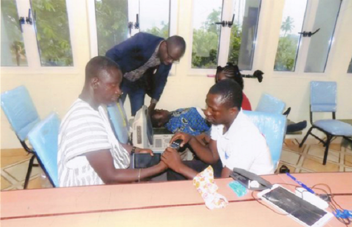 Dr Raphael Nyarkotey-Obu (standing, in glasses) and his team carrying out the screening of patients at Akyem Asene Dr Raphael Nyarkotey-Obu (standing, in glasses) and his team carrying out the screening of patients at Akyem Asene
