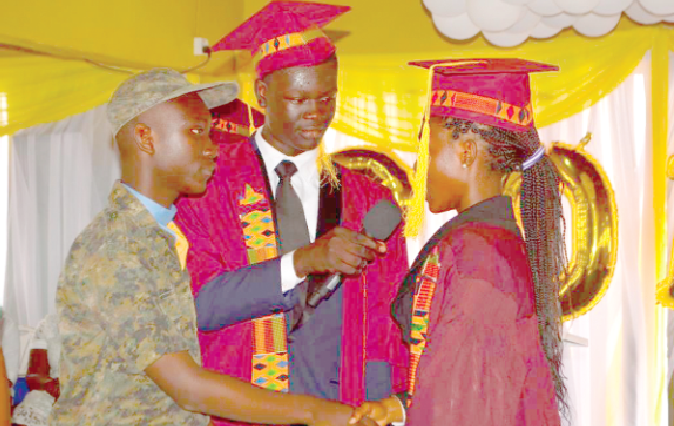 The outgoing head prefect, Miss Sharon Gandaa (right), handing over the baton to Mr Brian Dougan The outgoing head prefect, Miss Sharon Gandaa (right), handing over the baton to Mr Brian Dougan