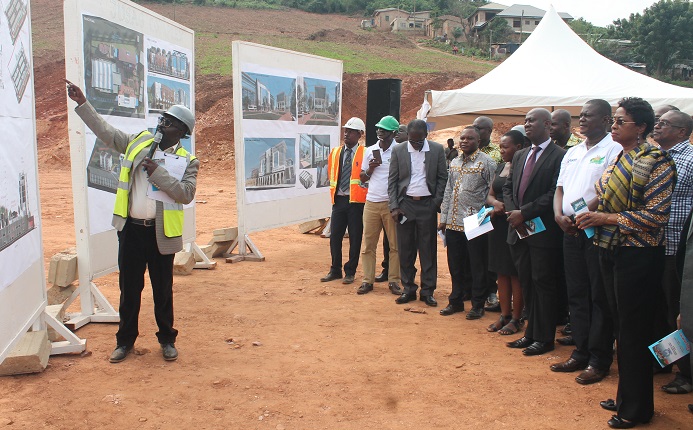 Mr Alexis Adu-Asare (left), Architect of Macdons Engineering Consult Limited, taking Ms Justice Sophia Akuffo (right) and the other dignitaries through the blueprint and architectural designs of the Judicial Service Staff Association of Ghana (JUSAG) complex