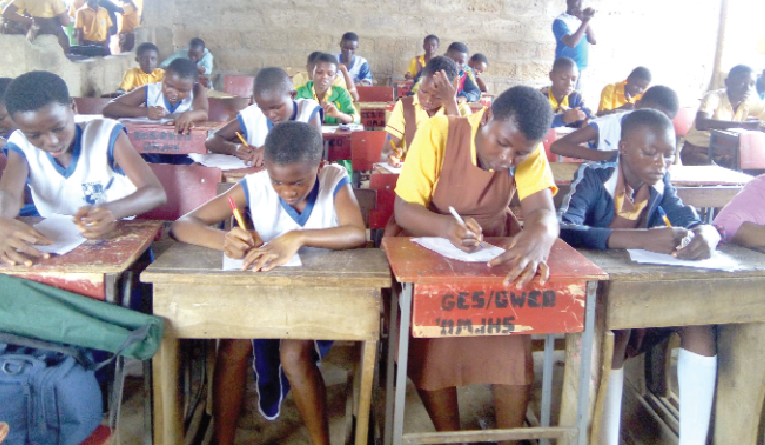 Some pupils taking part in a dictation conducted by the organisers to make their selection for the competition