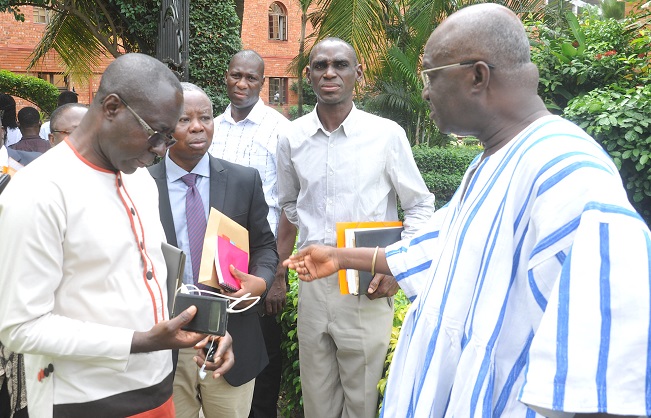 Mr Kofi Adda (right) interacting with some participants after the opening ceremony