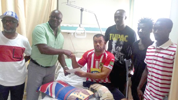 Coach Polack (on bed) receiving the cheques from the former Kotoko board member Coach Polack (on bed) receiving the cheques from the former Kotoko board member