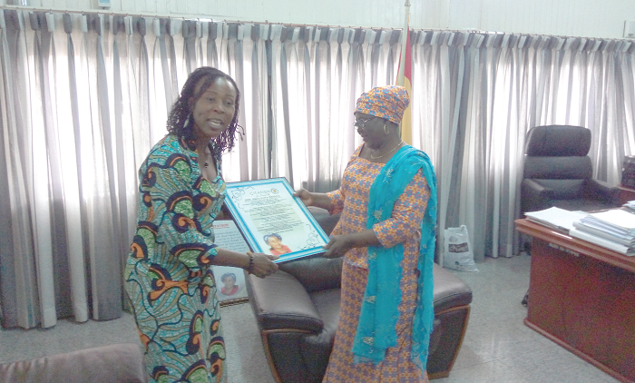 Ms Fati Seidu (left) presenting the citation to Hajia Alima