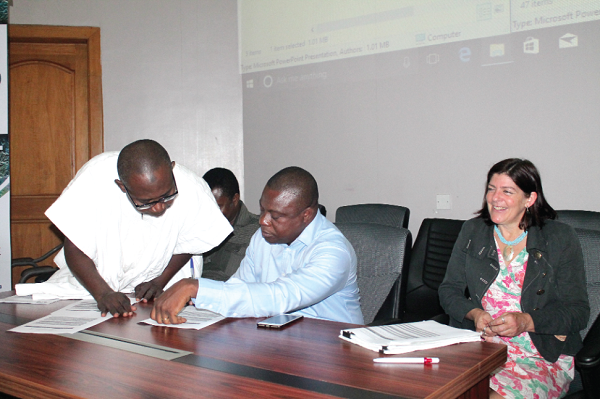 Mr John Allotey (2nd left) and Mr Yakubu Mohammed (left), Manager, Geographic Information Systems and Mapping at Forestry Commission, looking through some documents at the event. With them is Dr Ruth Malleson (3rd left), Manager of the Forests 2020 project. Picture: Maxwell Ocloo Mr John Allotey (2nd left) and Mr Yakubu Mohammed (left), Manager, Geographic Information Systems and Mapping at Forestry Commission, looking through some documents at the event. With them is Dr Ruth Malleson (3rd left), Manager of the Forests 2020 project. Picture: Maxwell Ocloo