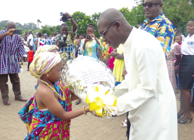 A young parishioner presenting a bouquet to Fr Anaman on the occasion of his Silver Jubilee Fr Anaman marks Silver Jubilee