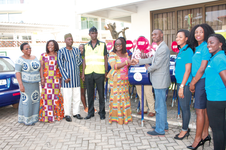 Mr Philip Oti-Mensah (right), the CEO of OmniBank, presenting the crossing stands to Mrs May Obiri Yeboah (left), the Executive Director of the National Road Safety Commission