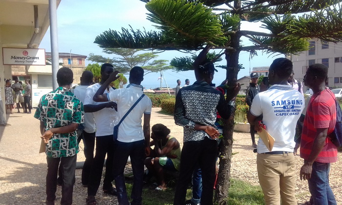 Some applicants standing around the premises of the Ghana Commercial Bank Cape Coast main branch waiting for their turns to apply Some applicants standing around the premises of the Ghana Commercial Bank Cape Coast main branch waiting for their turns to apply