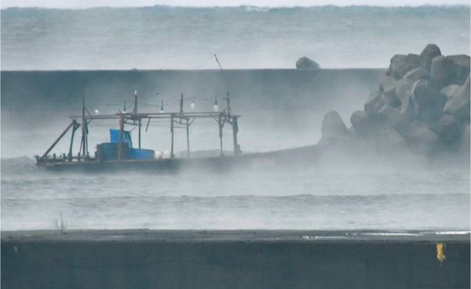 The men's boat was seen by a breakwater at Yurihonjo on Friday morning The men's boat was seen by a breakwater at Yurihonjo on Friday morning