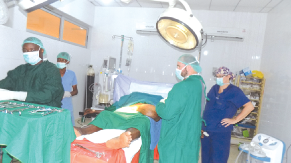 Members of the medical team operating on one of the patients Members of the medical team operating on one of the patients