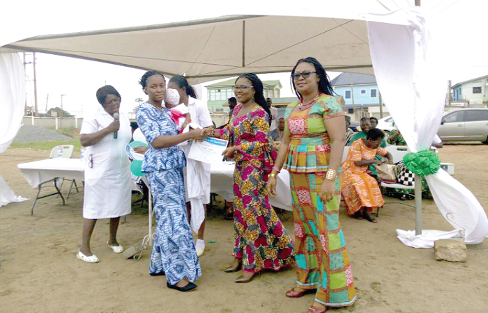 Ms Selorm  Degbor, one of the participants, receiving her certificate from the MCE of the La-Nkwantanang Municipal Assembly, Madam Jennifer Dede Afegbedzi