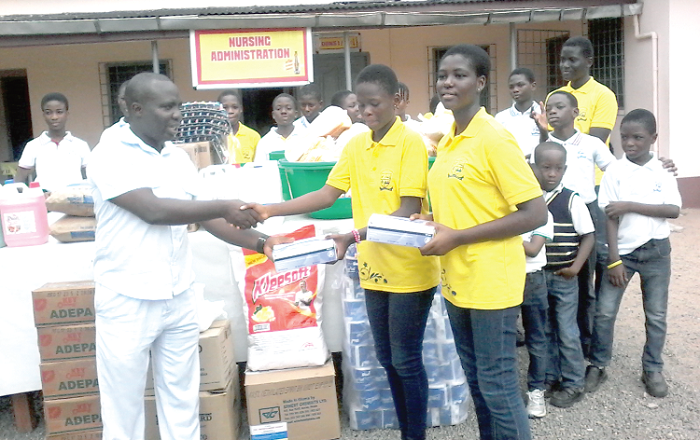 Maame Akoto Boateng (second right) presenting the items to Mr Owusu-Ansah Maame Akoto Boateng (second right) presenting the items to Mr Owusu-Ansah