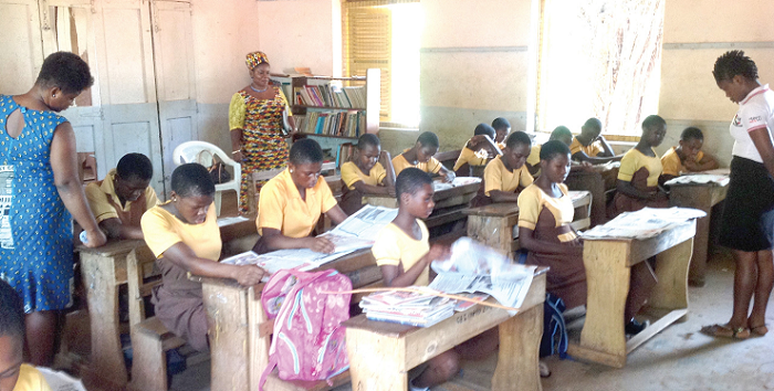 Some students of the Akosa MA JHS 1 going through pages of the Junior Graphic Some students of the Akosa MA JHS 1 going through pages of the Junior Graphic