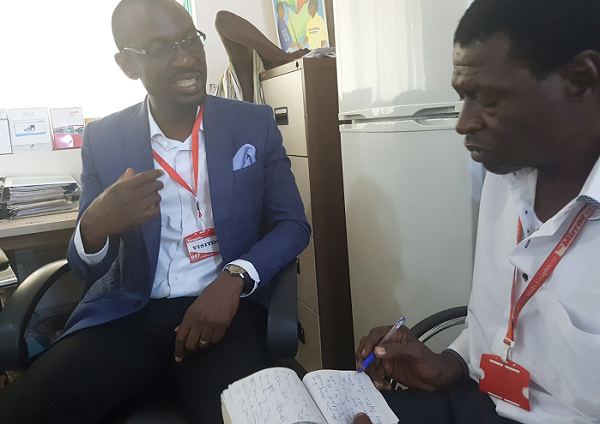 Mr Wilson Jnr.0explaining a point to Abdul Aziz, Staff Writer of the Daily Graphic  