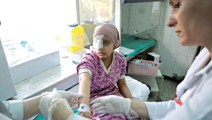 A doctor attending to a child with cancer A doctor attending to a child with cancer