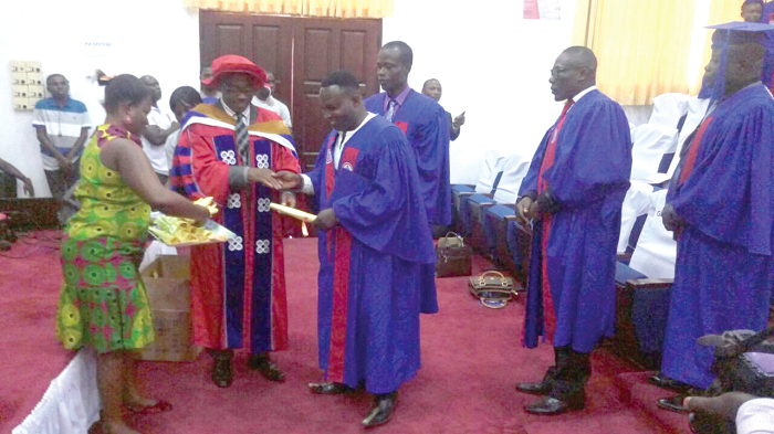 The graduates being presented with scrolls