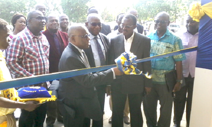 Mr Charles Darku (arrowed) cutting the tape. Looking on are Rev. William Garr (second right), Mr Ofori-Adjei (first) and other old students of the school.
