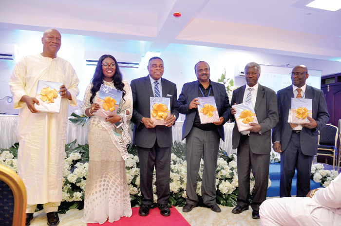 Prof. Josuah Alabi (left) with Prof. Goski Alabi (2rd left) and other dignitaries displaying the book at the launch Prof. Josuah Alabi (left) with Prof. Goski Alabi (2rd left) and other dignitaries displaying the book at the launch