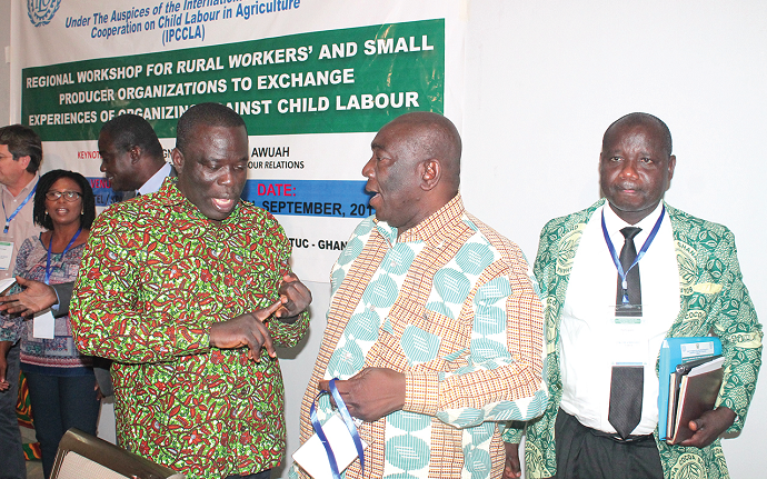 Mr Ignatius Baffour Awuah (left), Minister of Employment and Labour Relations, in an interaction with Mr Joshua Ansah (2nd left), Deputy Secretary General of TUC Ghana.