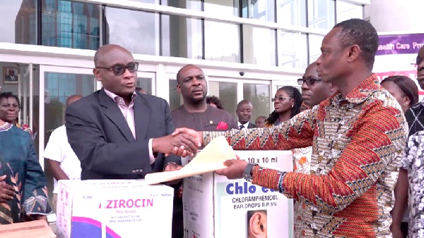 Mr Albert Yankey (left) receiving the items from Mr Ben Kpobi