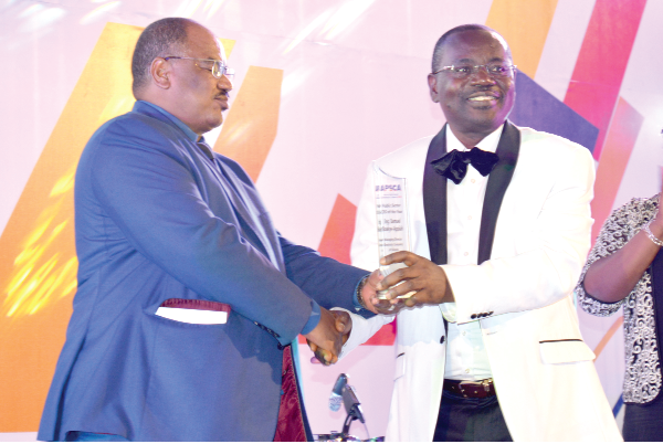 Mr Samuel Boakye–Appiah (right), the Managing Director of the Electricity Company of Ghana (ECG), receiving the award from one of the organisers of the event Mr Samuel Boakye–Appiah (right), the Managing Director of the Electricity Company of Ghana (ECG), receiving the award from one of the organisers of the event