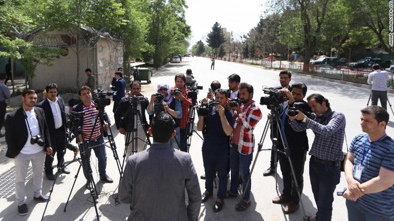 An official briefs journalists at the scene of the blasts in Kabul on Monday. An official briefs journalists at the scene of the blasts in Kabul on Monday.