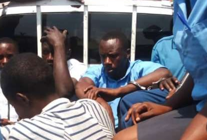 Mr Manirambona was handcuffed and taken away by police Mr Manirambona was handcuffed and taken away by police