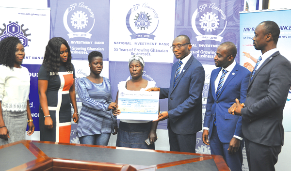 Mr Charles Wordey (3rd right), Head of Corporate Affairs, NIB, presenting a dummy cheque to Madam Rose Biney and Patience Addo. With them are some officials of Global Outreach Consortium and NIB Mr Charles Wordey (3rd right), Head of Corporate Affairs, NIB, presenting a dummy cheque to Madam Rose Biney and Patience Addo. With them are some officials of Global Outreach Consortium and NIB