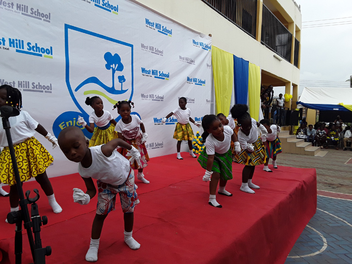 Children performing at a graduation