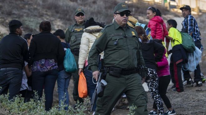 Migrants have tried to jump over the metal barrier to gain entry into the US Migrants have tried to jump over the metal barrier to gain entry into the US