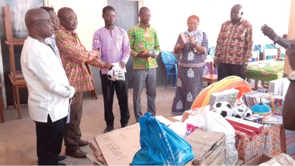 Mr Ernest Asamoah (3rd left) presenting the items to Mr Thomas Musah (4th left) of the Nadowli-Kaleo Directorate of Education, while other officials look on Mr Ernest Asamoah (3rd left) presenting the items to Mr Thomas Musah (4th left) of the Nadowli-Kaleo Directorate of Education, while other officials look on