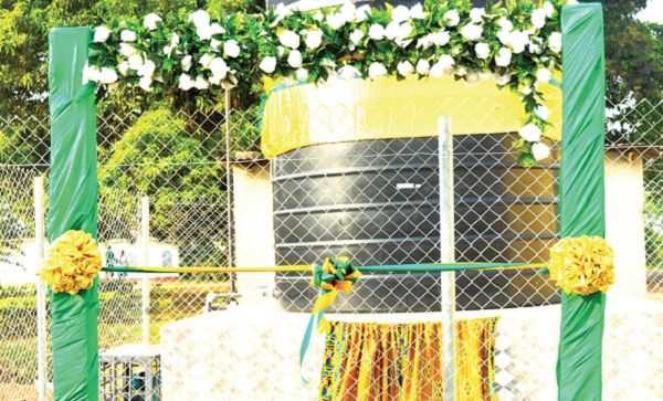 Rt Rev Moses Quayson, the immediate past Diocesan Bishop of the Methodist Church, Afigyaase (2nd right), cutting a ribbon to inaugurate the project with support from some members of the association