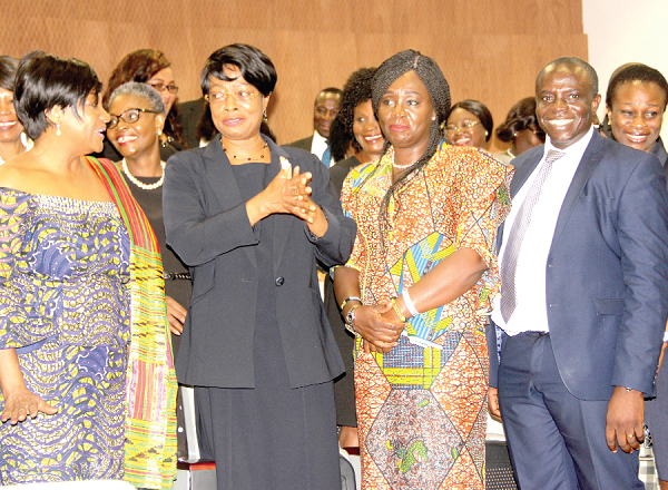 Ms Justice Sophia Akuffo (2nd left), the Chief Justice, explaining a point to Ms Otiko Afisa Djaba (left), the Minister of Gender, Children and Social Protection, after the workshop. Those with them are Mrs Gifty Twum-Ampofo (2nd right), Deputy Minister of Gender, Children and Social Protection, and Mr Justice Dennis Adjei (right), Justice of the Court of Appeal and Director of the Judicial Training Institute.